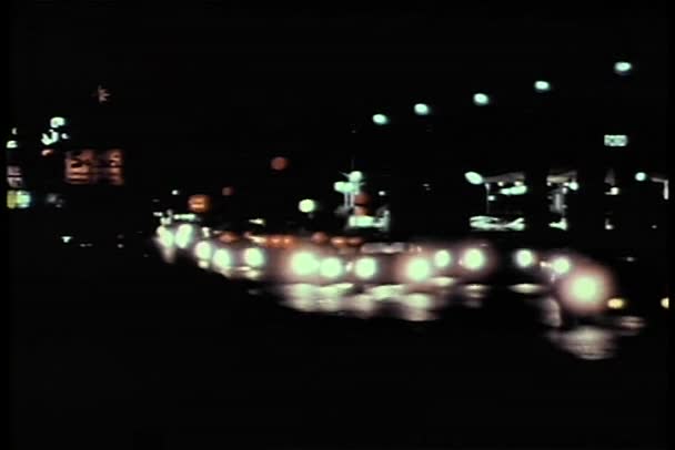 Cars with bright headlights driving on road at night — Stock Video