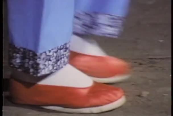 Close-up feet in red Chinese slippers walking across floor — Stock Video