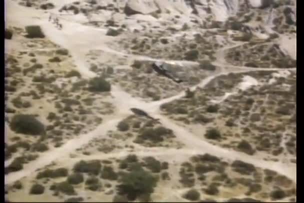 Aerial view of a helicopter flying over desert — Stock Video