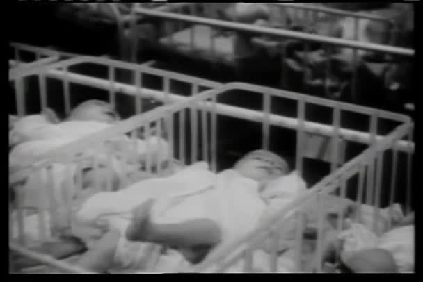 Rows of babies in cribs in hospital