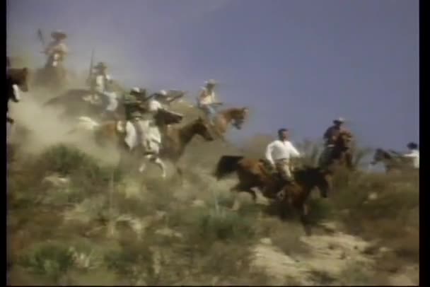 Armed men on horseback riding down mountain — Stock Video