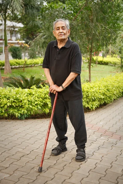 Old Asian man with walking stick — Stock Photo, Image