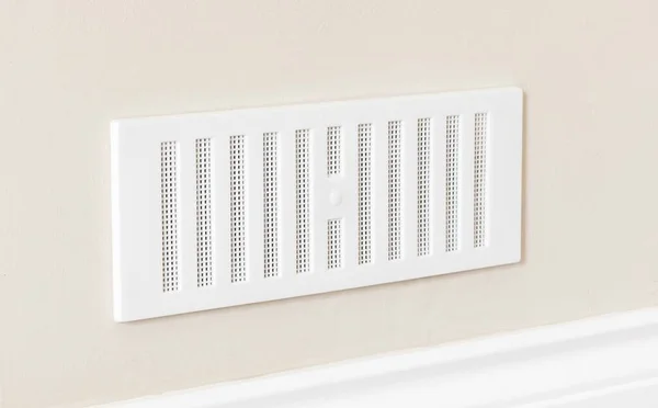 Adjustable air vent cover on the wall of a house. UK home ventilation with brick vents to improve air flow.