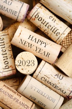 Happy New Year 2023 greeting card with wine corks. No visible trademarks clipart