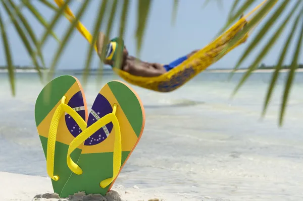 Člověk relaxuje v houpací síti na brazilské pláži — Stock fotografie