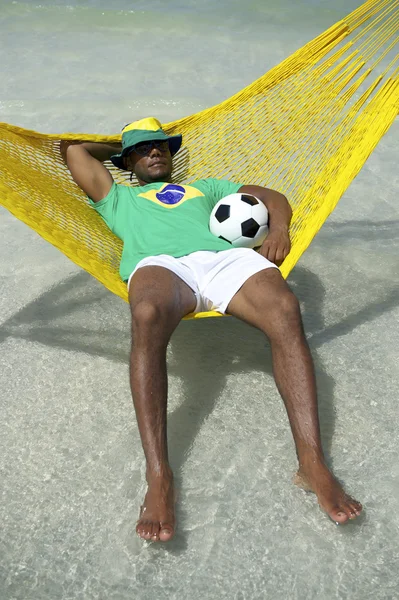 Brasil Man Relaxing with Soccer Football in Beach Hammock — Stok Foto