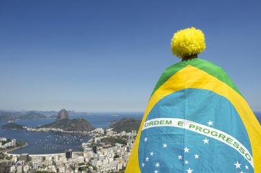 Patriotic Brazil Fan Standing Wrapped in Brazilian Flag Rio clipart