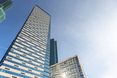 Ofis binaları duvarlara güneş ışığı saçıyor.