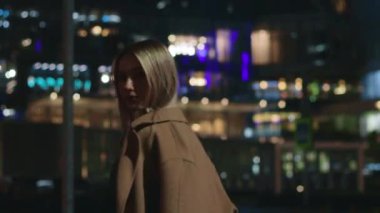 beautiful young girl blonde walks around the night city
