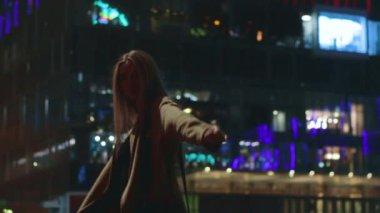 beautiful young girl blonde walks around the night city