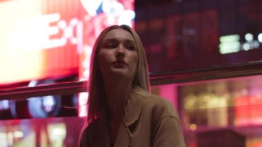 beautiful young girl blonde walks around the night city