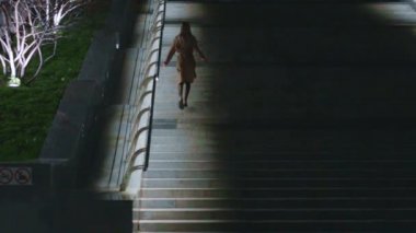 beautiful young girl blonde walks around the night city