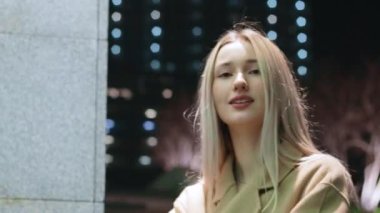 beautiful young girl blonde walks around the night city