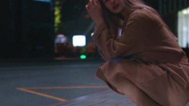beautiful young girl blonde walks around the night city