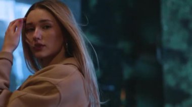 beautiful young girl blonde walks around the night city