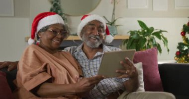 Mutlu Afro-Amerikan son sınıf çifti Noel zamanı video görüşmesi yapıyor. Noel, şenlik ve iletişim teknolojisi.