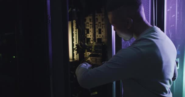 African American Male Computer Technician Using Smartphone Working Business Server — Stock Video