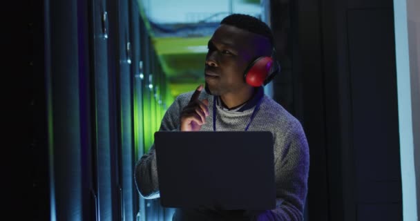 African American Male Computer Technician Using Laptop Working Business Server — Stock Video