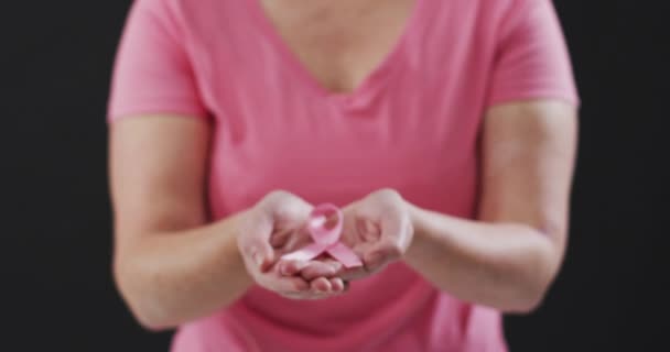 Mid Section Woman Holding Pink Ribbon Black Background Breast Cancer — Stock Video