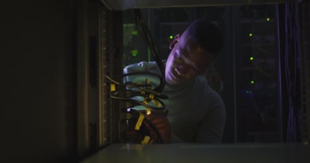African American Male Computer Technician Using Smartphone Working Business Server — Stock Video