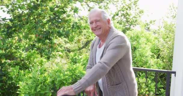 Portrét Usměvavého Staršího Muže Důchodu Oblečeného Svetru Opírajícího Zábradlí Balkóně — Stock video
