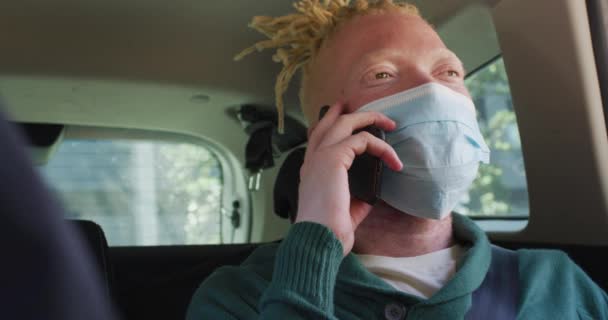 Happy Albino African American Man Wearing Face Mask Sitting Car — Stok Video
