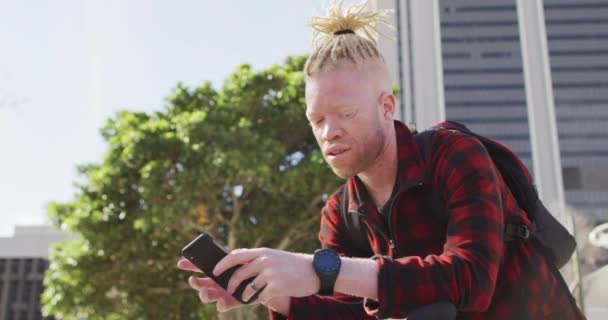 Homem Americano Albino Africano Pensativo Com Dreadlocks Usando Smartwatch Smartphone — Vídeo de Stock
