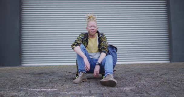 Portrait Homme Souriant Albinos Afro Américain Assis Sur Une Planche — Video