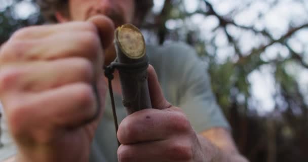 Bearded Caucasian Male Survivalist Tying Paracord Branch Make Fire Bow — Stock Video