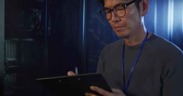 アジアの男性は タブレットチェックコンピュータサーバーを使用して技術者 情報技術 データ処理 コンピュータサーバー — ストック動画