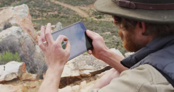 Bearded Caucasian Male Survivalist Sitting Mountain Using Tablet Exploration Travel — Stock Video