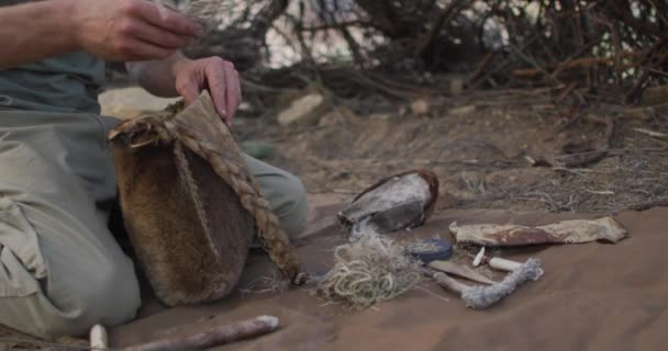 Caucasian Male Survivalist Unpacking Tinder Hide Bag Prepare Fire Camp — Stock Video