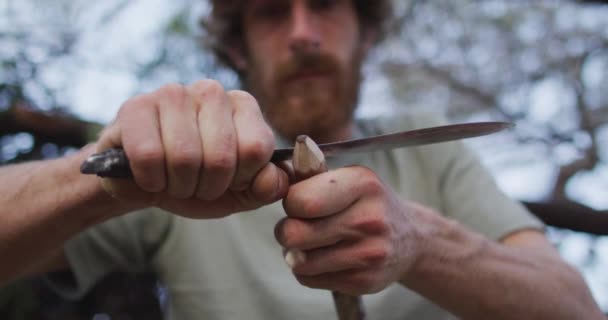 Caucasian Male Survivalist Cutting Point Stick Make Fire Drill Camp — Stock Video