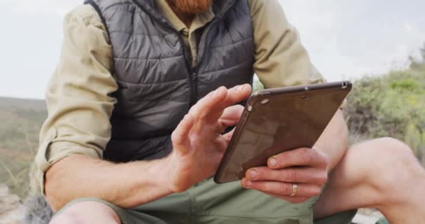 Mid Section Caucasian Male Survivalist Sitting Mountain Using Tablet Exploration — Stock Video