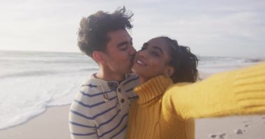 Mutlu İspanyol çiftin plajda selfie çekerken portresi. Tatiller, rahatlama, açık hava yaşam tarzı ve birliktelik..