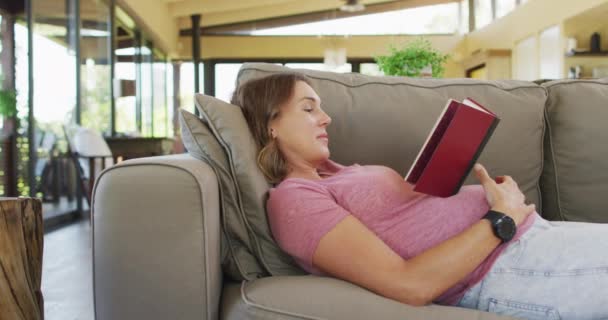 Relaxed Caucasian Pregnant Woman Lying Sofa Reading Book Pregnancy Expecting — Stock Video