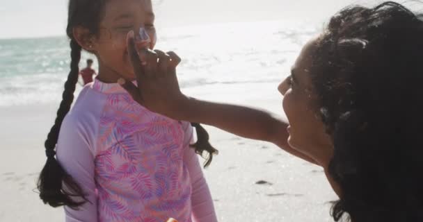 Happy Hispanic Mother Applying Sun Cream Daughter Face Beach Family — Stock Video