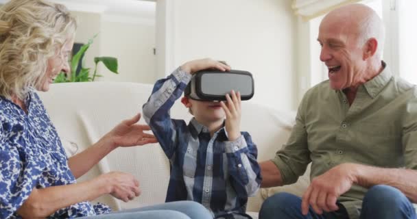 Happy Senior Caucasian Couple Grandson Using Headset Living Room Family — Stock video