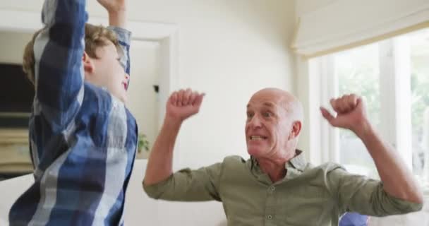 Happy Caucasian Grandfather Grandson Jumping Raising Hands Living Room Family — Αρχείο Βίντεο