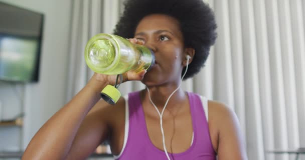 Glad Afrikansk Amerikan Klädd Sportkläder Med Smartphone Dricksvatten Inhemsk Livsstil — Stockvideo