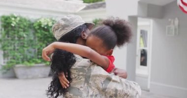 Mutlu Afro-Amerikan askerlerinin anne ve kızının kucaklaşmasının animasyonu. Aile, birliktelik, ordu ve Amerikan vatanseverliği kavramı.