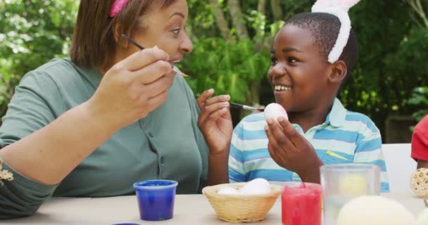 Animation Happy Diverse Grandmother Grandson Painting Easter Eggs Garden Family — Vídeos de Stock