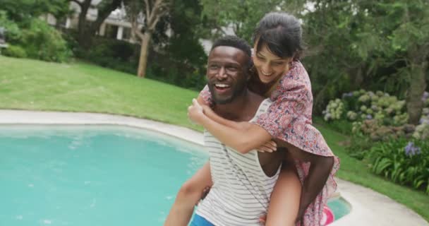 Happy Diverse Couple Swimming Pool Man Carrying Woman Garden Spending — Stock Video