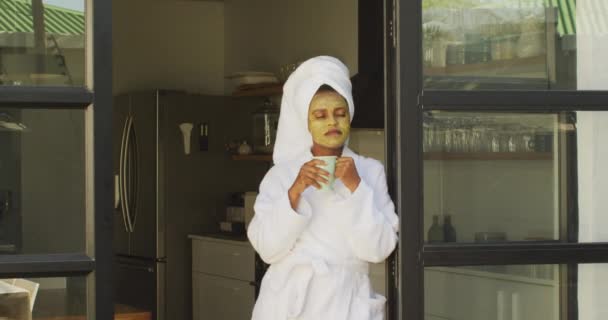 Happy African American Woman Beauty Mask Face Drinking Coffee Kitchen — Stock Video