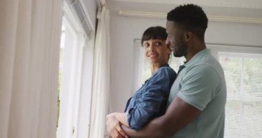 Ceket ve gömlek giyen ve oturma odasında kucaklaşan mutlu çift. Evde birlikte vakit geçirmek..