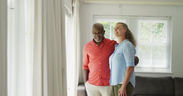 Счастливая Пожилая Пара Носящая Рубашки Обнимающаяся Гостиной Проводить Время Вместе — стоковое видео