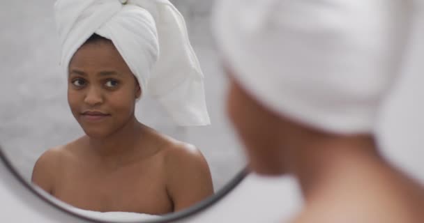 Happy Afro Amerikaanse Vrouw Aanbrengen Crème Het Gezicht Badkamer Binnenlandse — Stockvideo