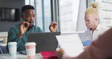 Çeşitli iş adamları yaratıcı ofisteki belgelerle tartışıyorlar. Yaratıcı ofiste iş ve finans.