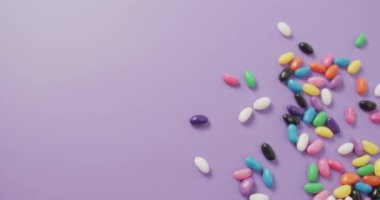 Mor arkaplan üzerinde fotokopi alanı olan çok renkli tatlıların genel görünümü. Füzyon yiyecek ve tatlı konsepti.