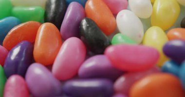 Video of close up of multiple multi coloured sweets background. fusion food and sweets concept.